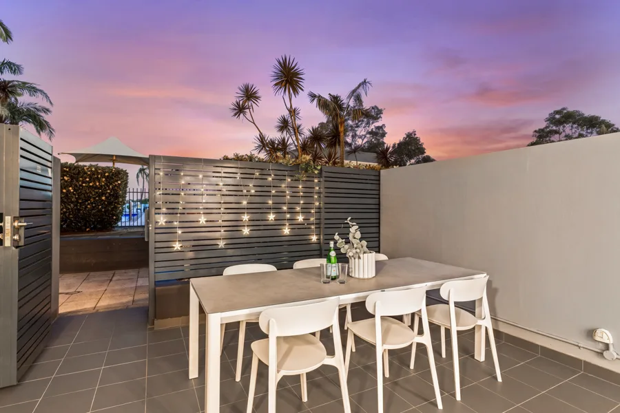 The rental's private courtyard at dusk, with an outdoor dining setting
